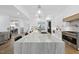 Bright, open kitchen with a large center island and view of dining and living areas at 5305 Dixon Dr, Raleigh, NC 27609