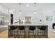 Open-concept kitchen featuring a large island with seating and pendant lighting at 5305 Dixon Dr, Raleigh, NC 27609