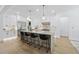 Spacious, white gourmet kitchen with a large island, black stools, and modern appliances at 5305 Dixon Dr, Raleigh, NC 27609