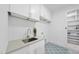 Bright laundry room with white cabinetry, quartz counters, and stylish tiled floor at 5305 Dixon Dr, Raleigh, NC 27609