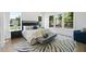Serene main bedroom featuring large windows, a zebra rug, and a comfortable seating area at 5305 Dixon Dr, Raleigh, NC 27609