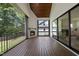 Screened-in patio with wood ceiling, fireplace, and sliding doors leading to the backyard at 5305 Dixon Dr, Raleigh, NC 27609