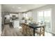 Open-concept kitchen flows into dining area with sliding glass doors and stainless steel appliances at 356 N Coral Bells Way Way, Four Oaks, NC 27524