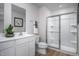 Well-lit bathroom showcasing modern vanity, toilet, and glass-enclosed shower at 356 N Coral Bells Way Way, Four Oaks, NC 27524