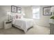 Light bedroom with a white bed, soft carpet, and bright, natural light at 356 N Coral Bells Way Way, Four Oaks, NC 27524