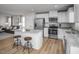Modern kitchen featuring stainless steel appliances, granite countertops, and a breakfast bar with seating at 356 N Coral Bells Way Way, Four Oaks, NC 27524
