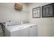 Convenient laundry room featuring a washer, dryer, and shelving for storage at 356 N Coral Bells Way Way, Four Oaks, NC 27524