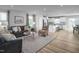 Inviting living room showcasing hardwood floors and a view of the open-concept kitchen and dining area at 356 N Coral Bells Way Way, Four Oaks, NC 27524