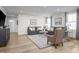 Bright living room with neutral walls, wood floors, and comfortable gray sofas at 356 N Coral Bells Way Way, Four Oaks, NC 27524