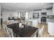 Open-concept kitchen and living area, with modern appliances and stylish furnishings at 356 N Coral Bells Way Way, Four Oaks, NC 27524