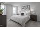 Comfortable main bedroom featuring soft carpet, neutral walls, and large window at 356 N Coral Bells Way Way, Four Oaks, NC 27524
