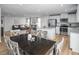 Open-concept living space with a view of the kitchen, featuring modern finishes and plenty of natural light at 356 N Coral Bells Way Way, Four Oaks, NC 27524