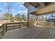 Spacious wood deck with railing overlooking a landscaped backyard with trees at 100 Farris Ct, Raleigh, NC 27610