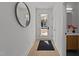 Inviting entryway with light wood floors, white walls, and a modern round mirror at 100 Farris Ct, Raleigh, NC 27610