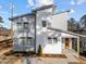 Contemporary home with gray siding, an orange front door, and neatly landscaped yard at 100 Farris Ct, Raleigh, NC 27610