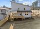 Rear exterior of a modern home with a spacious deck and yard at 100 Farris Ct, Raleigh, NC 27610