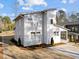 Modern home with gray siding, a sloped roof, and freshly mulched landscaping at 100 Farris Ct, Raleigh, NC 27610