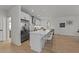 Bright, spacious kitchen featuring white cabinets, stainless steel refrigerator, and bar stool seating at 100 Farris Ct, Raleigh, NC 27610