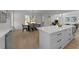 Open-concept kitchen and dining room area with white cabinets, stainless steel appliances, and an island at 100 Farris Ct, Raleigh, NC 27610