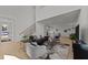 Open-concept living area with hardwood floors, a staircase, and access to the kitchen at 100 Farris Ct, Raleigh, NC 27610