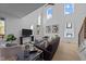 Spacious living room with soaring ceilings, large windows, and contemporary decor at 100 Farris Ct, Raleigh, NC 27610