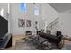 Modern living room with tall ceilings, stylish furniture, and large windows at 100 Farris Ct, Raleigh, NC 27610