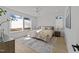 Bright bedroom with large windows, hardwood floors, a ceiling fan, and natural light at 100 Farris Ct, Raleigh, NC 27610