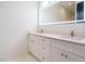 Modern bathroom with double vanity, white cabinets, and large illuminated mirror at 1521 Havenmont Ct, Raleigh, NC 27608