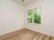 This bedroom features hardwood floors and a large window offering lots of natural light at 1521 Havenmont Ct, Raleigh, NC 27608