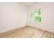 Bedroom features hardwood floors and a large window offering lots of natural light at 1521 Havenmont Ct, Raleigh, NC 27608