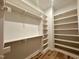 Spacious walk-in closet with built-in shelving and wooden floors at 1521 Havenmont Ct, Raleigh, NC 27608