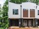 Modern townhome featuring brick accents, a single-car garage, and contemporary design elements at 1521 Havenmont Ct, Raleigh, NC 27608