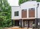 Modern townhome featuring brick accents, a single-car garage, and contemporary design elements at 1521 Havenmont Ct, Raleigh, NC 27608