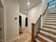 Hallway featuring wood floors, staircase with wood treads and railing, neutral wall colors at 1521 Havenmont Ct, Raleigh, NC 27608