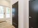 Hallway featuring black interior doors, hardwood floors, and French doors leading to the exterior at 1521 Havenmont Ct, Raleigh, NC 27608