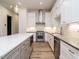 Modern kitchen boasts stainless steel appliances, white cabinetry, a central island, and stylish lighting at 1521 Havenmont Ct, Raleigh, NC 27608