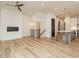 Open-concept living area with fireplace, staircase, and island separating the space from the kitchen at 1521 Havenmont Ct, Raleigh, NC 27608