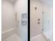 Elegant walk-in shower with built-in seat, dual showerheads and geometric tile accents at 1521 Havenmont Ct, Raleigh, NC 27608