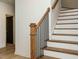 Elegant staircase with wood treads and a black metal railing adds a touch of sophistication at 1521 Havenmont Ct, Raleigh, NC 27608