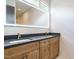 Bathroom featuring double sink vanity with modern fixtures and a large, illuminated mirror at 1523 Havenmont Ct, Raleigh, NC 27608