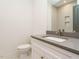 Bathroom vanity with gray countertop, undermount sink, and elegant gold faucet at 1523 Havenmont Ct, Raleigh, NC 27608