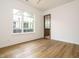 Bright bedroom with wood floors, large window, and ensuite bathroom entrance at 1523 Havenmont Ct, Raleigh, NC 27608