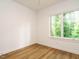 Bright bedroom with hardwood floors and large picture window overlooking nature at 1523 Havenmont Ct, Raleigh, NC 27608