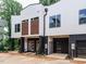 Modern townhome exterior showcasing the sleek design, private garages, and a well-maintained landscape at 1523 Havenmont Ct, Raleigh, NC 27608