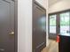 Hallway featuring gray doors with gold handles and a glass door to the outside area at 1523 Havenmont Ct, Raleigh, NC 27608