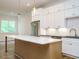 Bright open-concept kitchen with a large island, stainless steel appliances, and ample storage space at 1523 Havenmont Ct, Raleigh, NC 27608