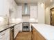 Modern kitchen featuring white cabinetry, stainless steel appliances, and a spacious marble-top island at 1523 Havenmont Ct, Raleigh, NC 27608