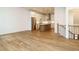 Open-concept living area with wood flooring, staircase, and view into the modern kitchen at 1523 Havenmont Ct, Raleigh, NC 27608