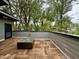 Inviting rooftop deck featuring wood tile flooring and a modern fire pit, perfect for outdoor relaxation and entertaining at 1523 Havenmont Ct, Raleigh, NC 27608