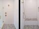Contemporary shower features white vertical tiles, gold fixtures and a mosaic tiled shower floor at 1523 Havenmont Ct, Raleigh, NC 27608
